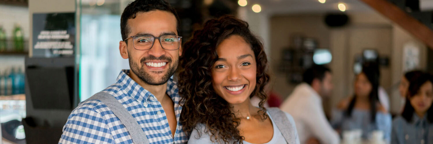 Smiling couple pose during a party at their new home TEMP-PACK mobile storage Texas
