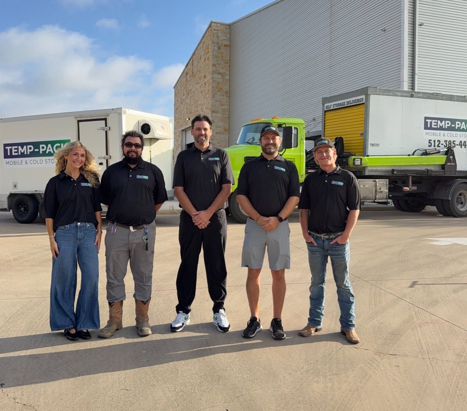The five TEMP-PACK team members outside their Buda warehouse with company vehicles